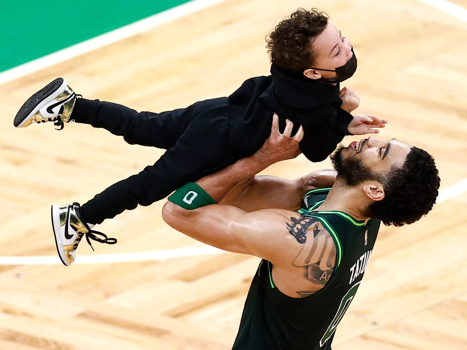 Jayson Tatum #0 of the Boston Celtics holds his son Deuce Tatum on the court after the Celtics defeat the Charlotte Hornets 120-111 at TD Garden on April 28, 2021 in Boston, Massachusetts