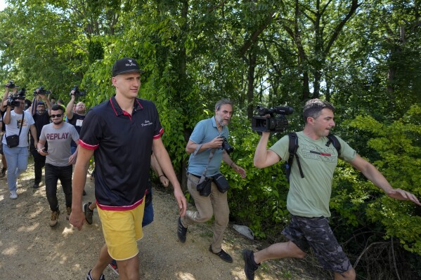 Denver Nuggets star Nikola Jokic arrives at the hippodrome in the northern Serbian town of Sombor, Sunday, June 18, 2023. Jokic came to Serbia after the Denver Nuggets won the NBA Championship with a victory over the Miami Heat in Game 5 of basketball's NBA Finals. (AP Photo/Darko Vojinovic)