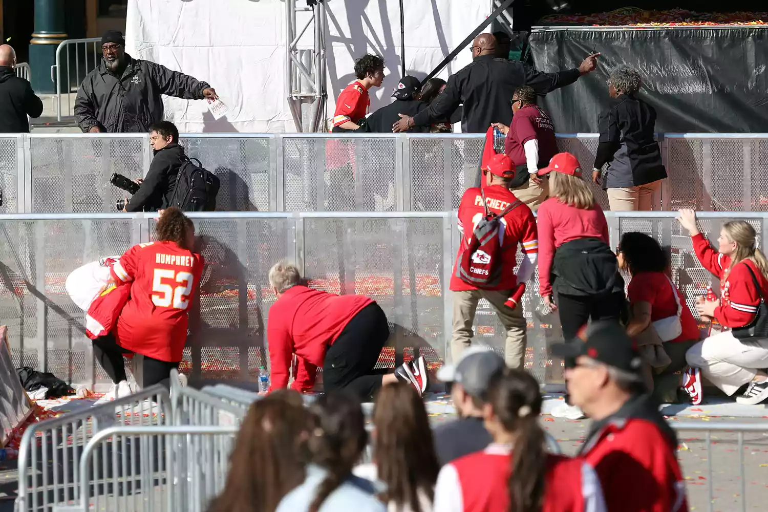 People take cover during a shooting at Union Station during the Kansas City Chiefs Super Bowl LVIII victory parade on February 14, 2024 in Kansas City, Missouri. Several people were shot and two people were detained after a rally celebrating the Chiefs Super Bowl victory.