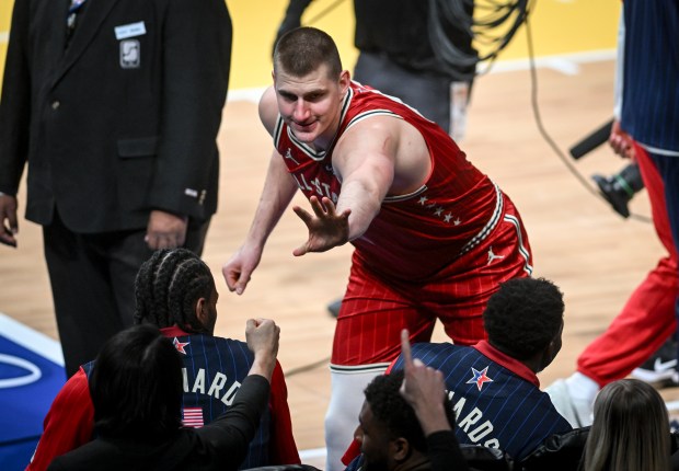 Nikola Jokic (15) of the Denver Nuggets high fives and knucks every member of the West before the NBA All-Star game at Gainbridge Fieldhouse in Indianapolis, Indiana on Sunday, Feb. 18, 2024. (Photo by AAron Ontiveroz/The Denver Post)