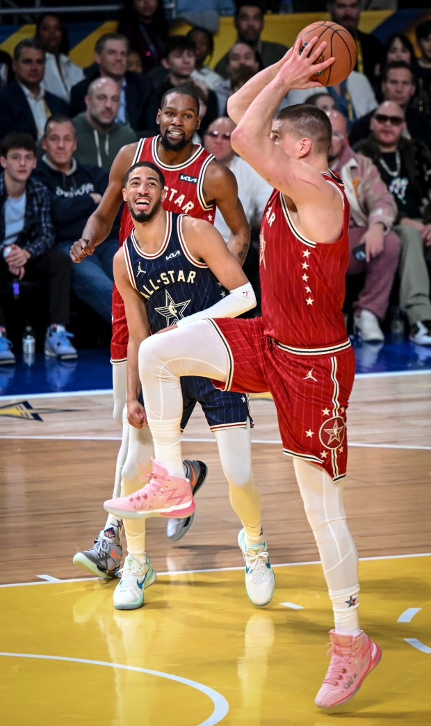 Nikola Jokic (15) of the Denver Nuggets cracks up Tyrese Haliburton (0) of the Indiana Pacers and Kevin Durant (35) of the Phoenix Suns as he fakes a dunk before lightly laying the ball in during the NBA All-Star game at Gainbridge Fieldhouse in Indianapolis, Indiana on Sunday, Feb. 18, 2024. (Photo by AAron Ontiveroz/The Denver Post)