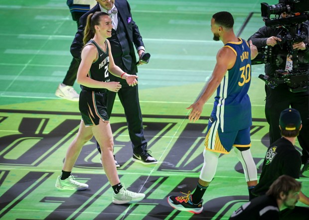 Steph Curry (30) of the Golden State Warriors celebrates after defeating New York Liberty star Sabrina Ionescu (20) during an NBA All-Star Three-Point shootout at Lucas Oil Stadium in Indianapolis, Indiana on Saturday, Feb. 17, 2024. (Photo by AAron Ontiveroz/The Denver Post)