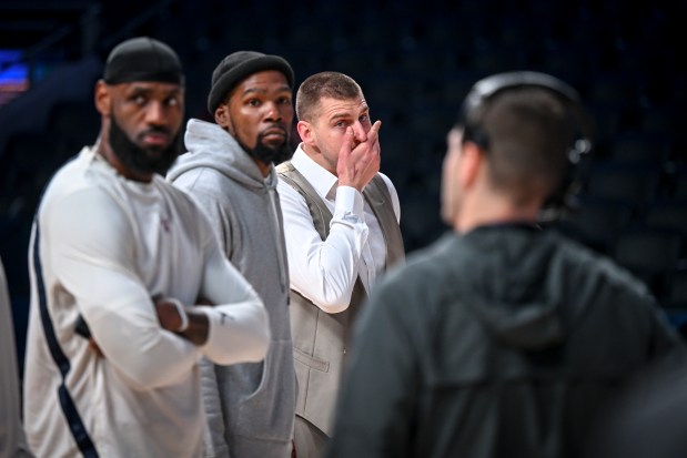 Nikola Jokic (15) of the Denver Nuggets stands with LeBron James (23) of the Los Angeles Lakers and Kevin Durant (35) of the Phoenix Suns as they take orders on the presentation of pregame activities during the NBA All-Star game at Gainbridge Fieldhouse in Indianapolis, Indiana on Sunday, Feb. 18, 2024. (Photo by AAron Ontiveroz/The Denver Post)