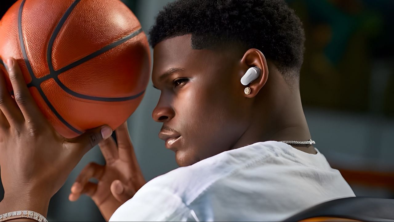 Anthony Edwards posing with a basketball