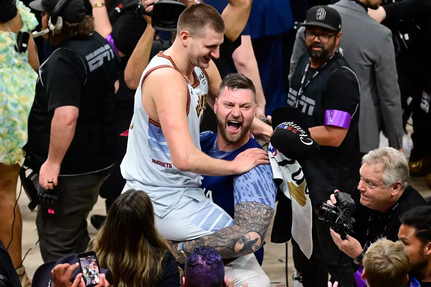 Nikola Jokic (15) of the Denver Nuggets celebrates the NBA championship with his brother Strahinja after defeating the Miami Heat 94-89 at Ball Arena June 12, 2023.