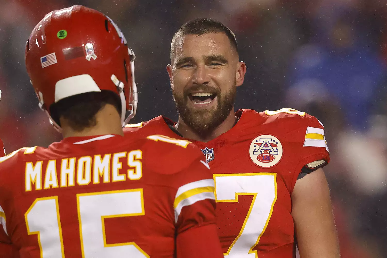 Travis Kelce #87 of the Kansas City Chiefs talks to Patrick Mahomes #15 before their game against the Philadelphia Eagles