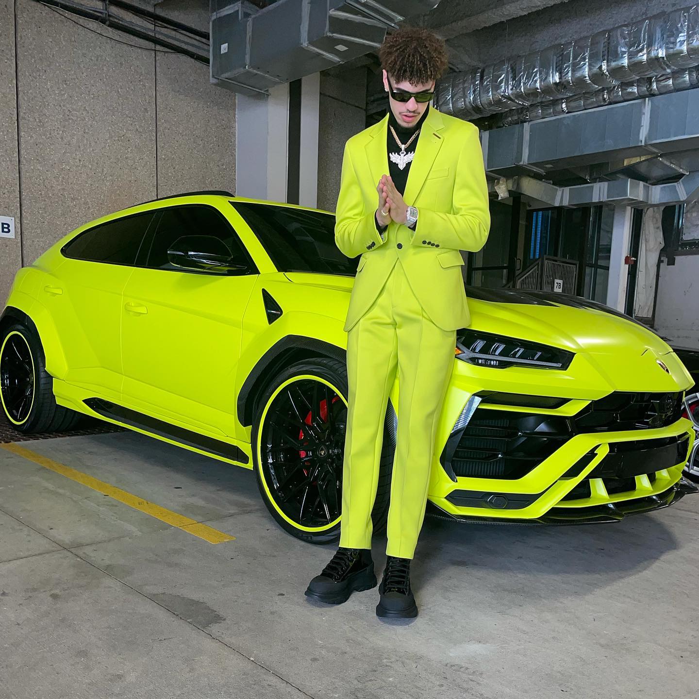 Lonzo Ball matches his suit to his Lamborghini Urus