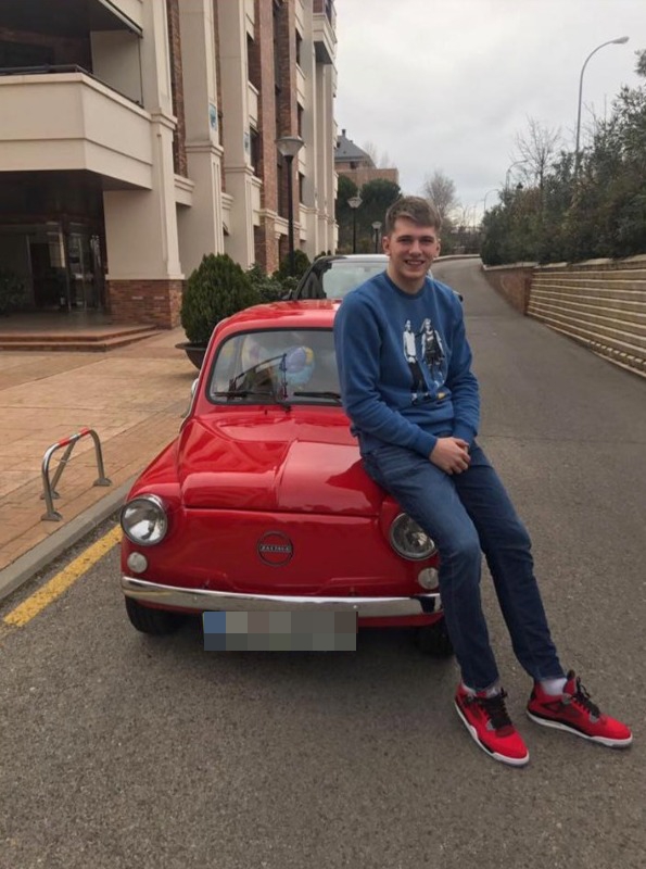 Luke Doncic leaning on his Zastava 750 car that’s modeled after Fiat 600