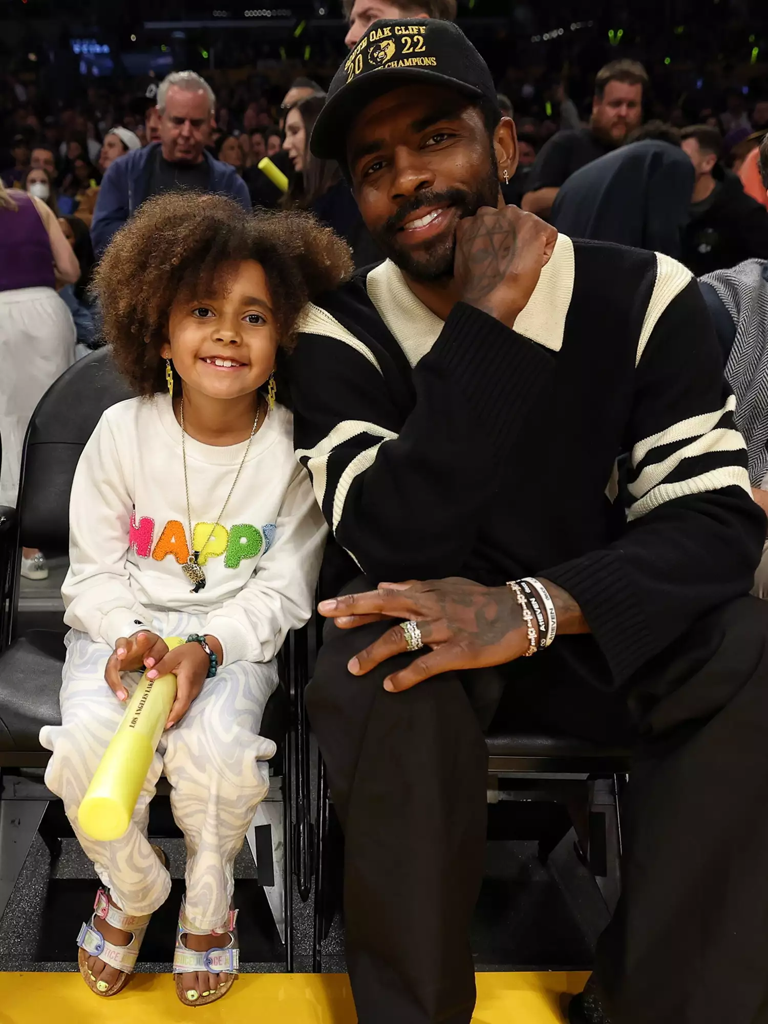 Kyrie Irving and his daughter Azurie during Round 1 Game 6 of the 2023 NBA Playoffs 