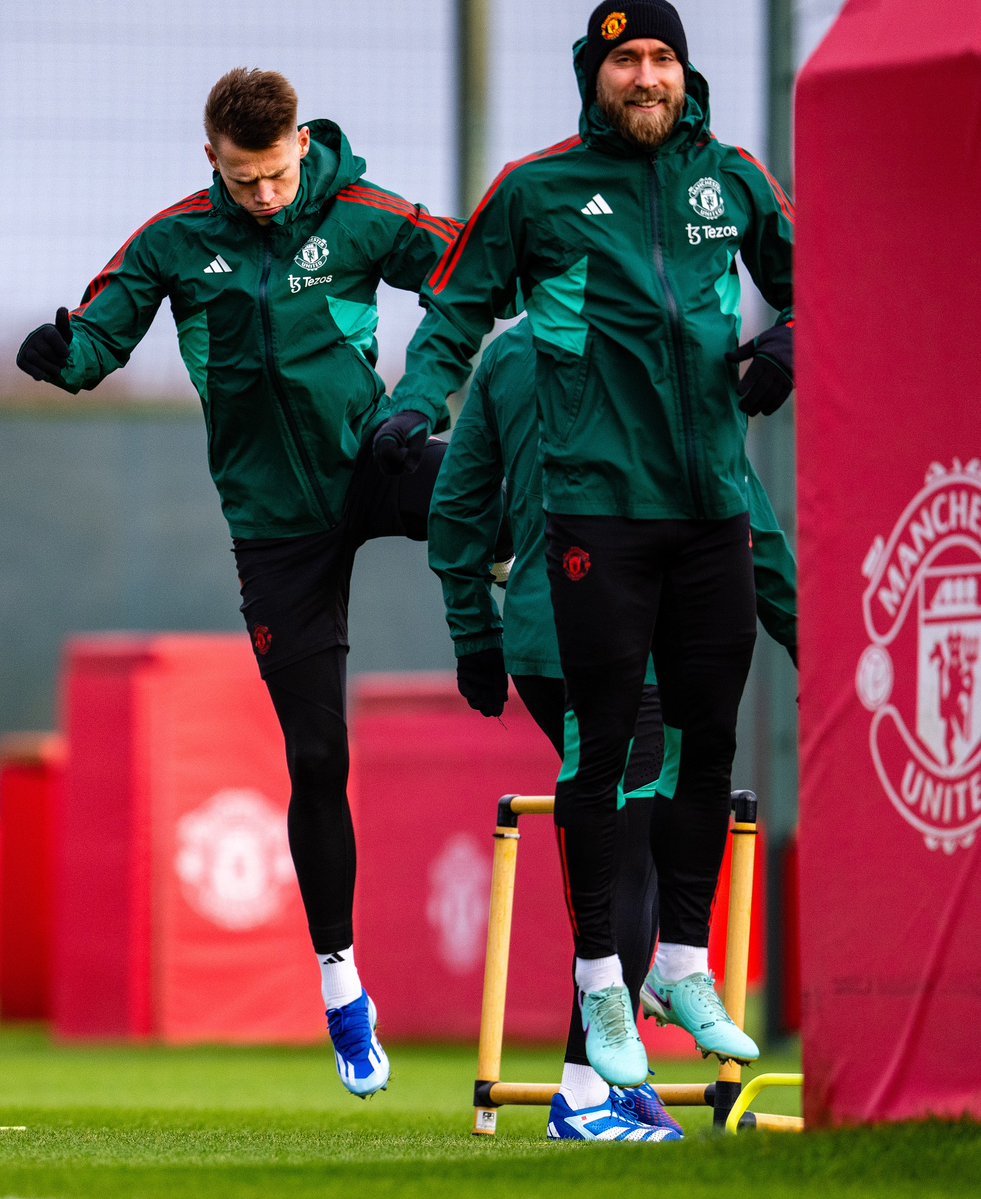 Scott McTominay and Christian Eriksen warm up for training at Carrington.