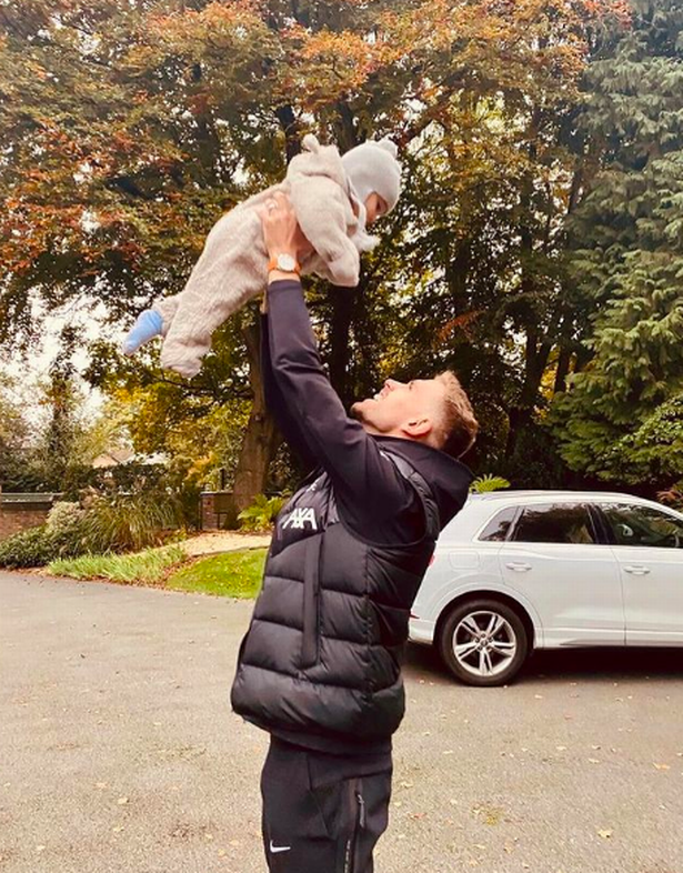 Jordan and his baby in his driveway