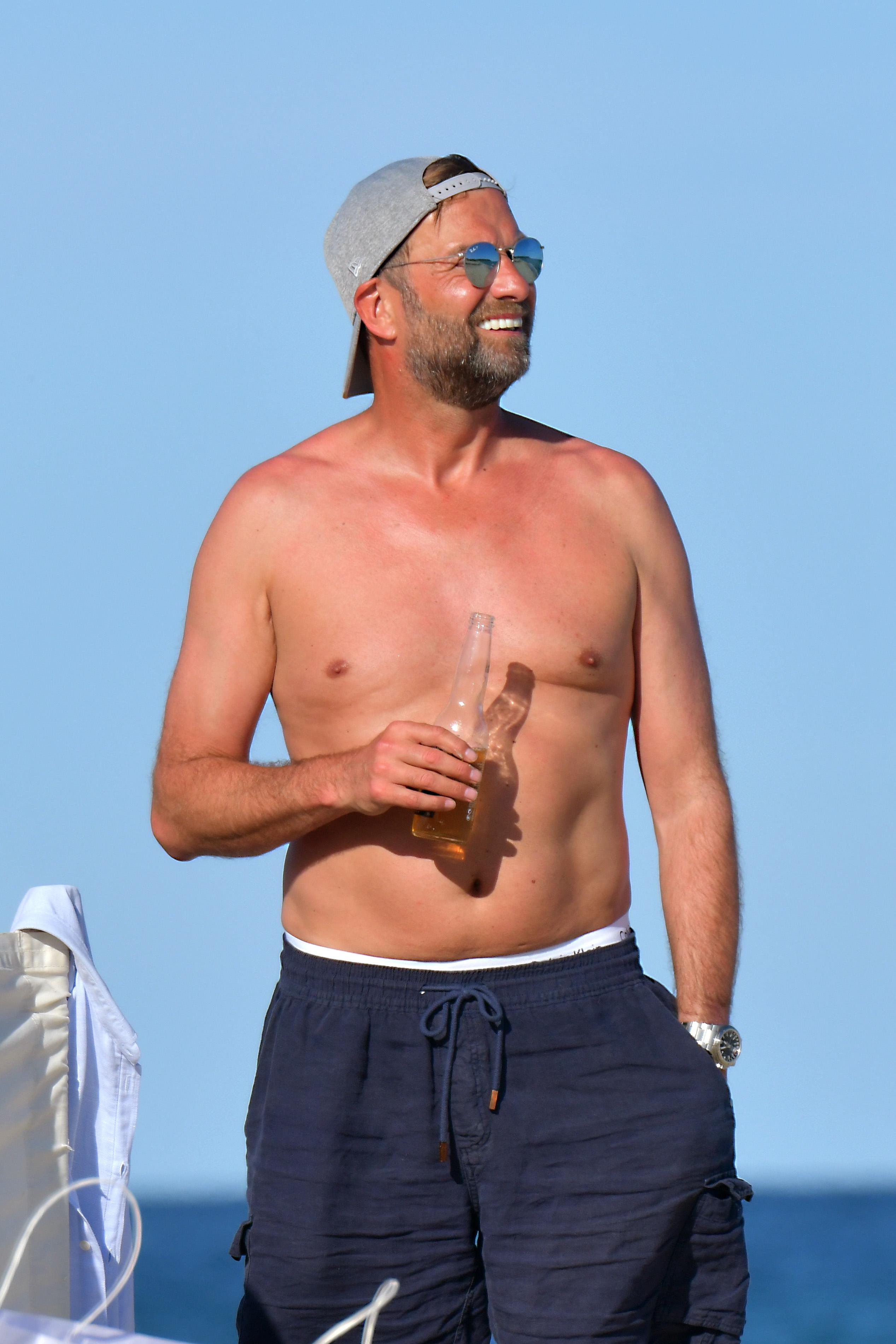  Klopp looked a relaxed figure as he topped up his tan
