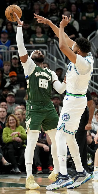 Minnesota Timberwolves center Karl-Anthony Towns (32) passes over Milwaukee Bucks forward Jae Crowder (99) during the first half of their game Thursday, February 8, 2024 at Fiserv Forum in Milwaukee, Wisconsin.