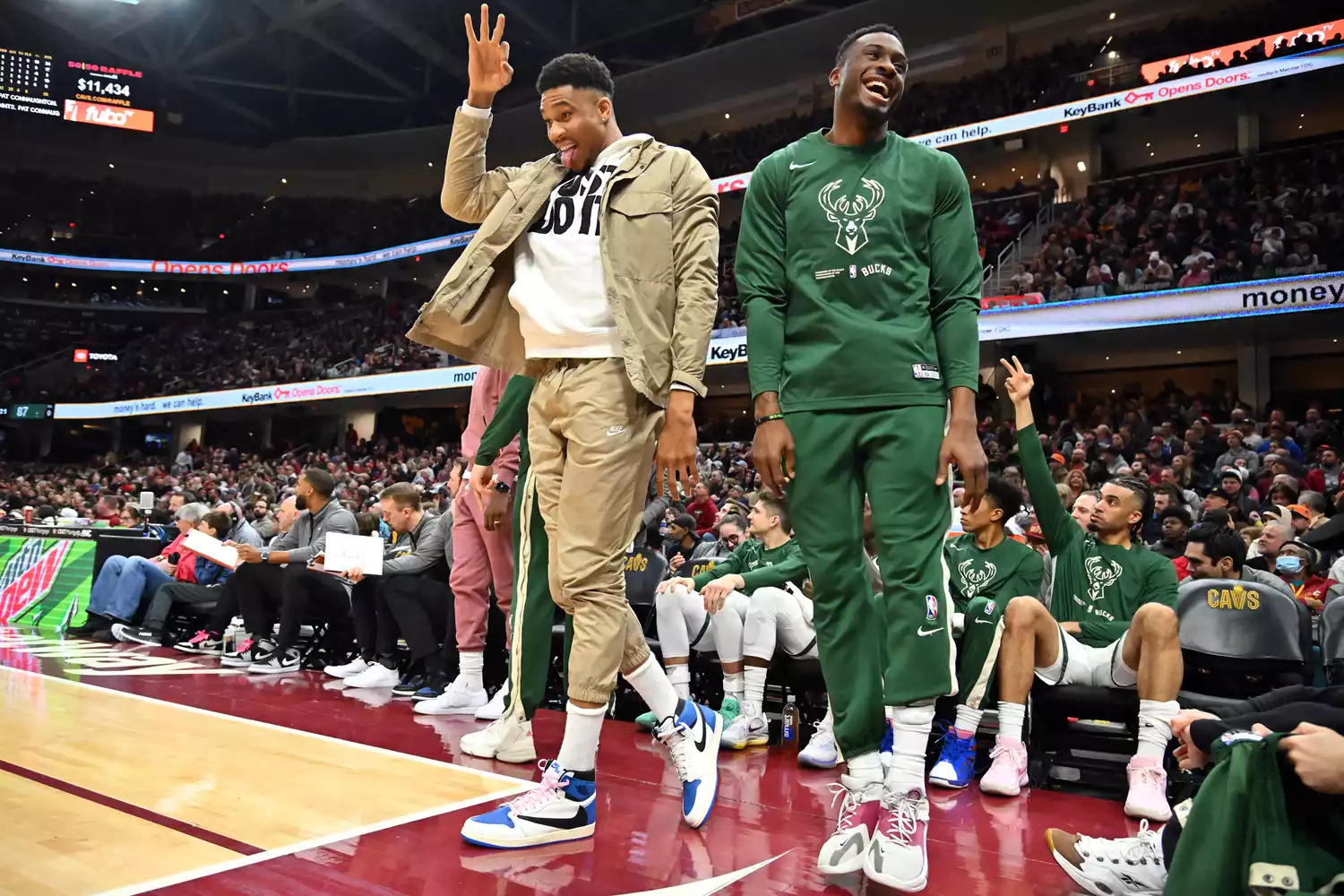 Giannis Antetokounmpo #34 and Thanasis Antetokounmpo #43 of the Milwaukee Bucks celebrate from the bench during the second half against the Cleveland Cavaliers at Rocket Mortgage Fieldhouse on January 21, 2023 in Cleveland, Ohio. The Cavaliers defeated the Bucks 114-102.