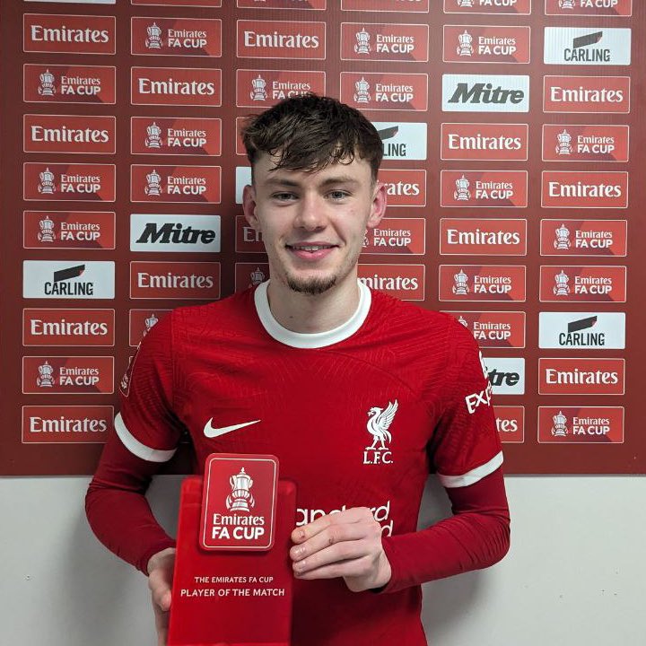 An image of Conor Bradley of Liverpool holding the Emirates Player of the Match award