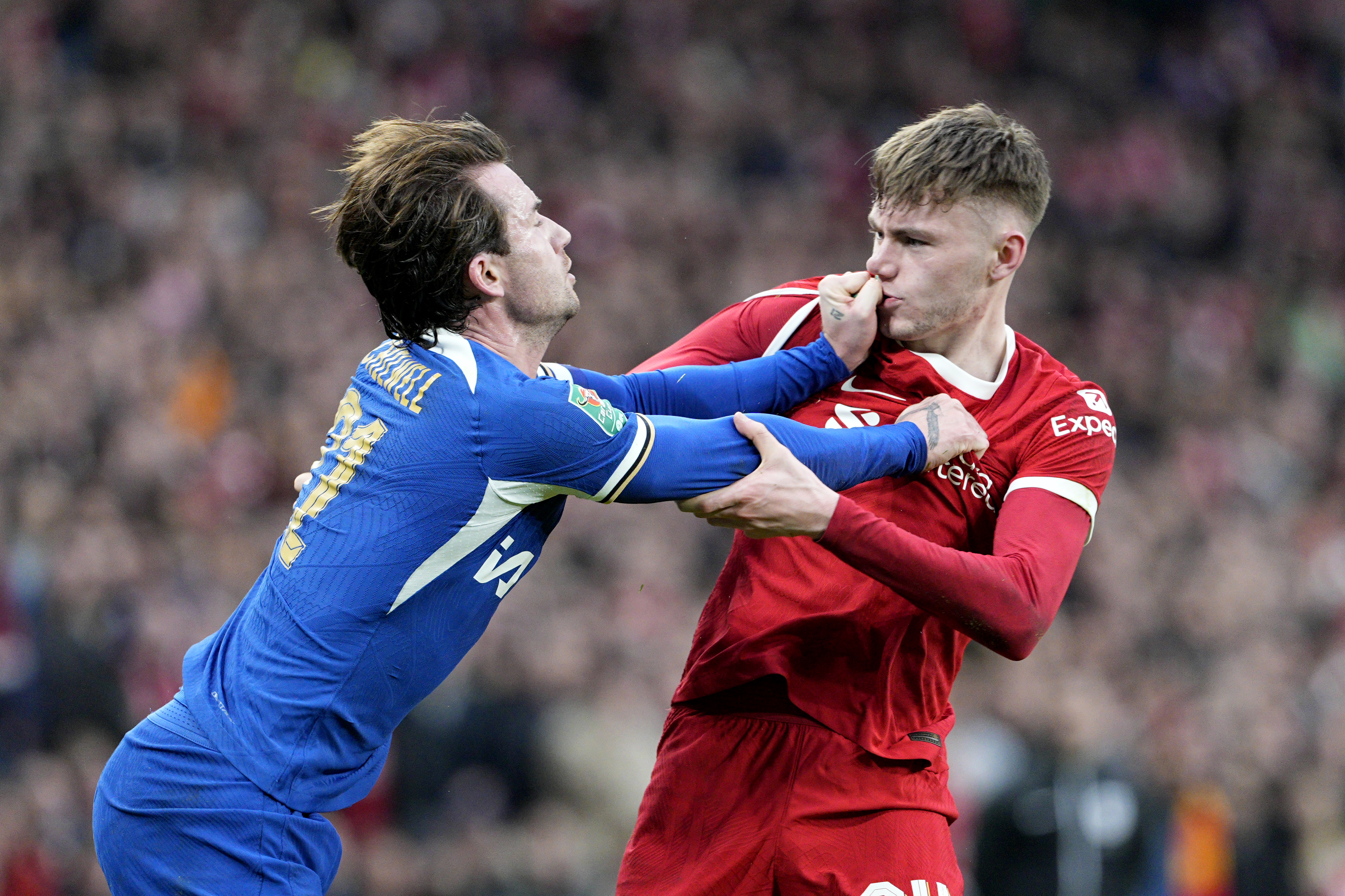 The duo engaged in a grappling match while tussling for the ball