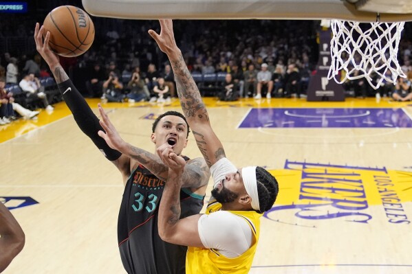 Washington Wizards forward Kyle Kuzma, left, shoots as Los Angeles Lakers forward Anthony Davis defends during the first half of an NBA basketball game Thursday, Feb. 29, 2024, in Los Angeles. (AP Photo/Mark J. Terrill)