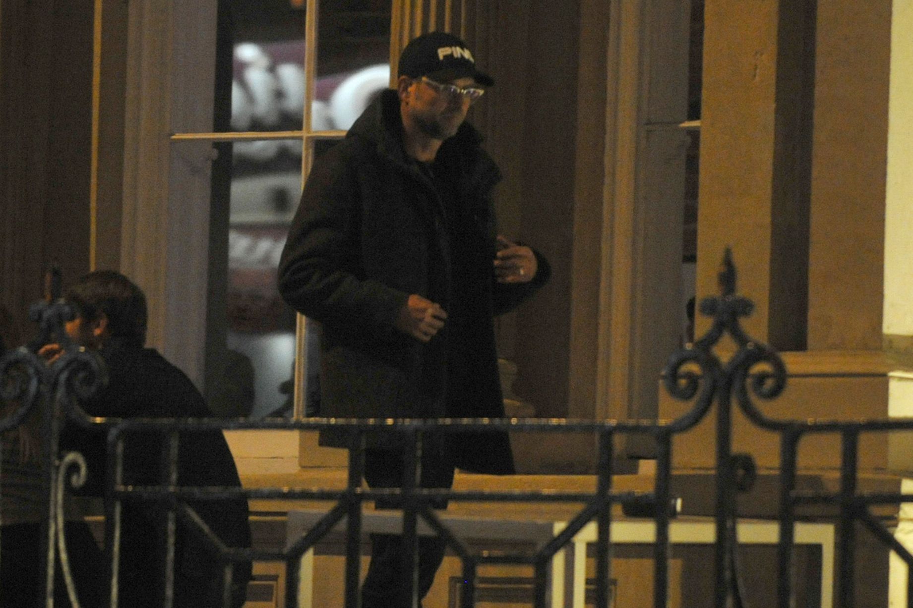 Jurgen in the "The Old Blind School" bar with his hood up drinking beers and smoking with his wife Ulla and son