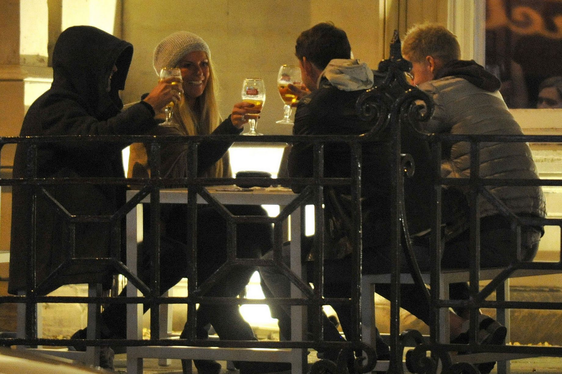 Jurgen in the "The Old Blind School" bar with his hood up drinking beers and smoking with his wife Ulla and son