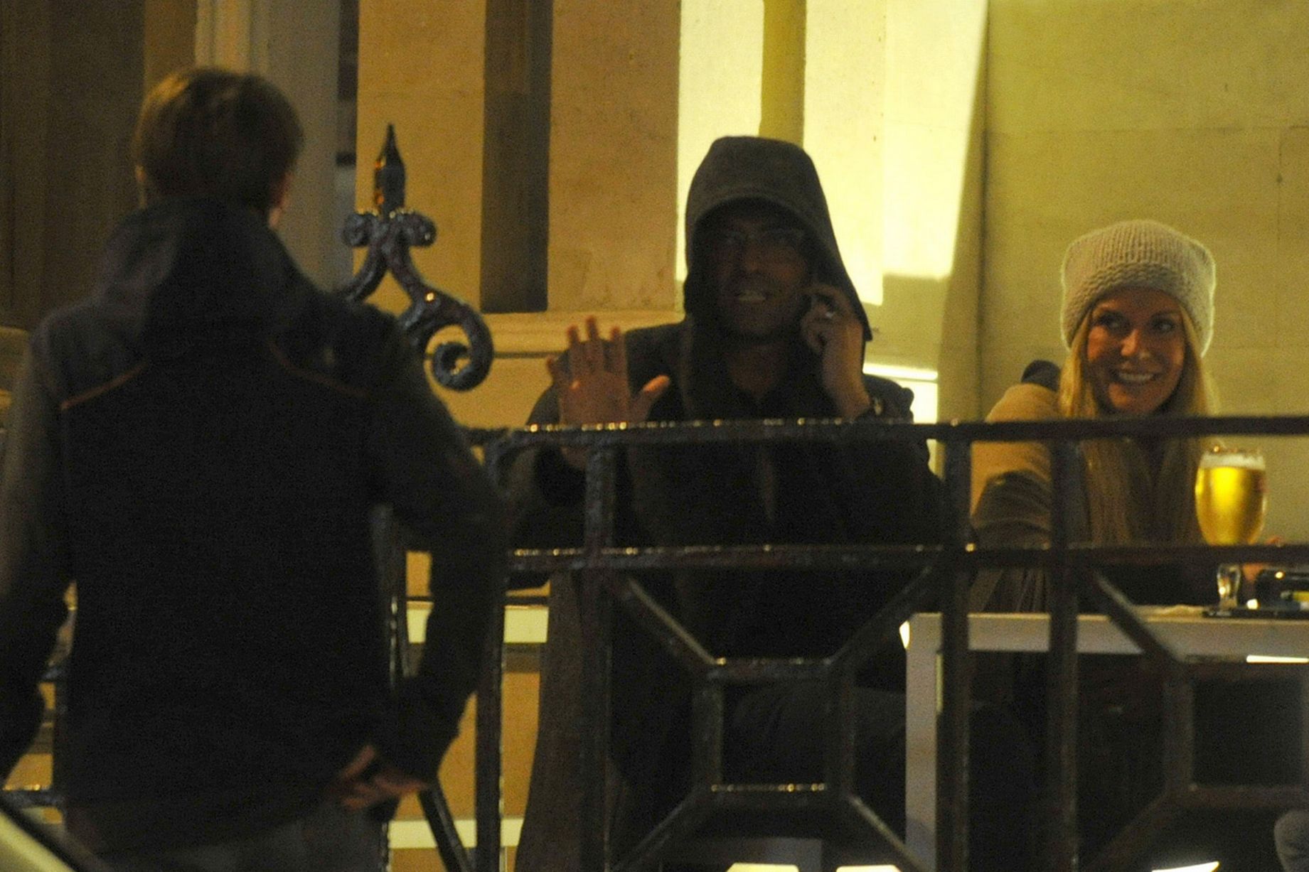 Jurgen in the "The Old Blind School" bar with his hood up drinking beers and smoking with his wife Ulla and son