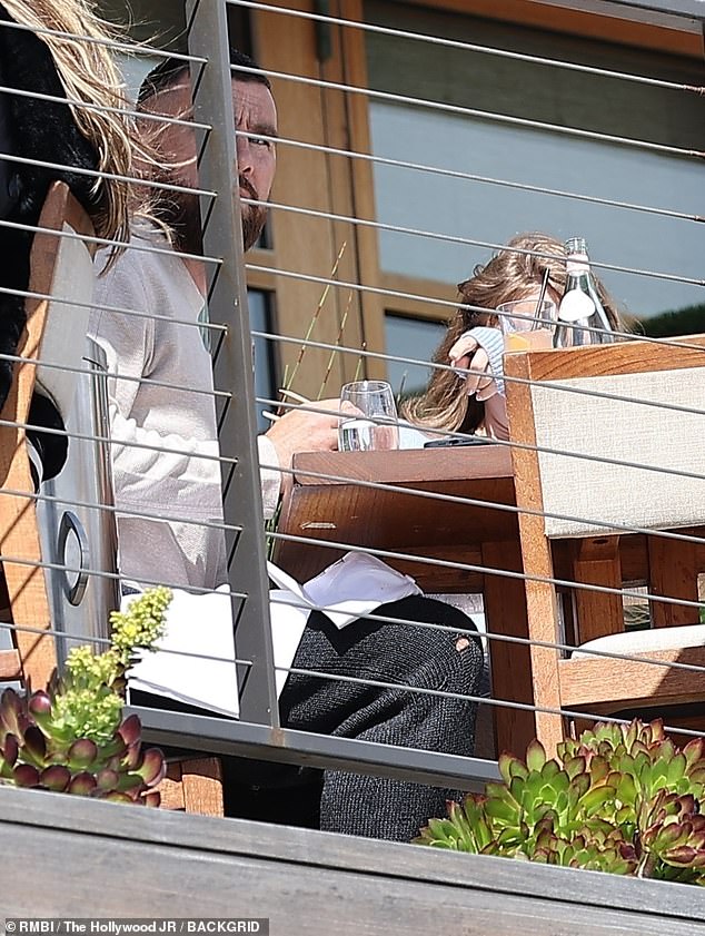 Seated at an outdoor table, the pair soaked up the sunshine at the oceanfront restaurant