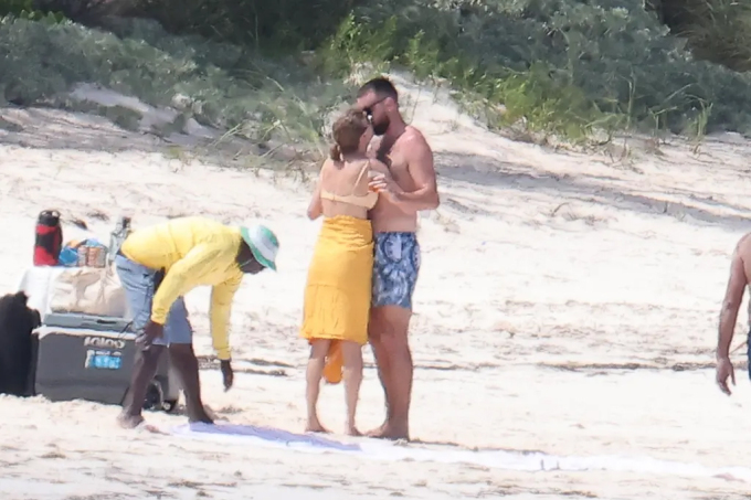 While on the beach, the couple continued to kiss each other passionately.