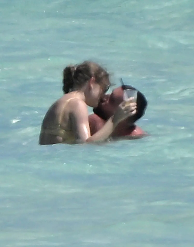 In the photos posted by Page Six, Taylor Swift and Travis Kelce locked lips while swimming on Harbor Island in the Bahamas on March 21.