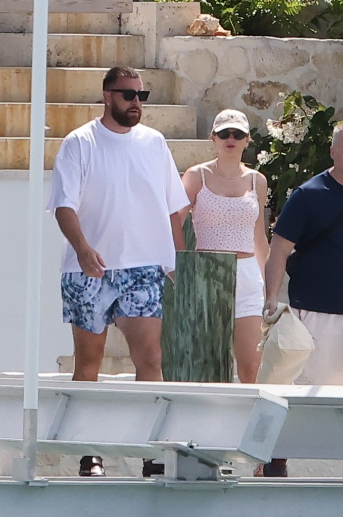 Travis Kelce and Taylor Swift hold hands in the Bahamas on vacation.