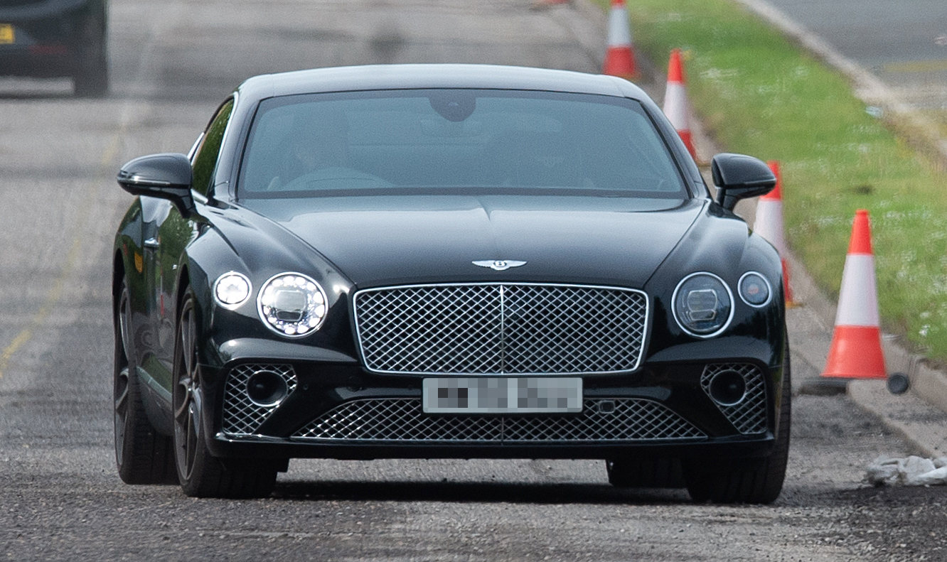 Liverpool manager Jurgen Klopp shows how he splashes the Reddies as he arrives for training in a £150,000 Bentley