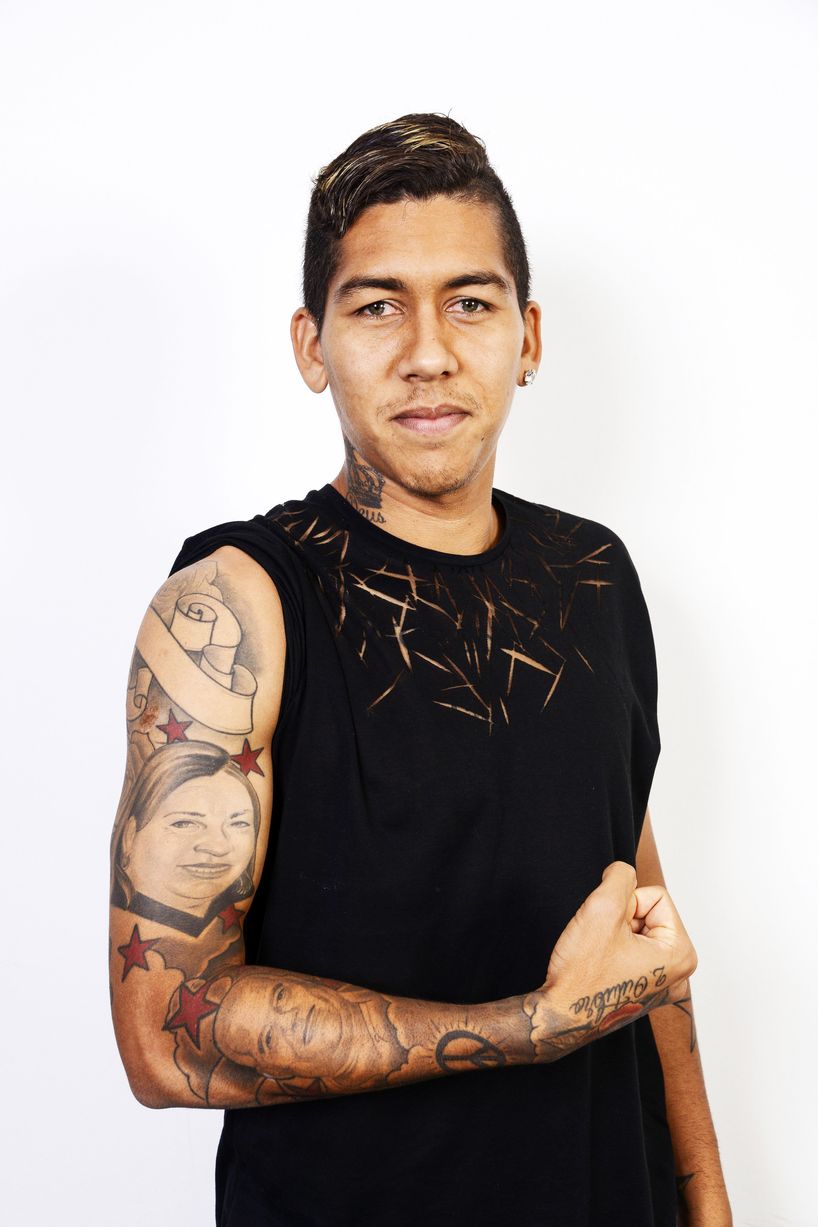 Brazilian footballer Firmino shows his tattoos