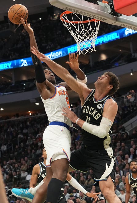 Milwaukee Bucks center Brook Lopez (11) thwarts New York Knicks forward OG Anunoby (8) from scoring during the first half of their game Sunday, April 7, 2024 at Fiserv Forum in Milwaukee, Wisconsin.