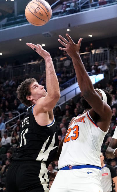 Milwaukee Bucks center Brook Lopez (11) and New York Knicks center Mitchell Robinson vie for a rebound during the first half of their game Sunday, April 7, 2024 at Fiserv Forum in Milwaukee, Wisconsin.