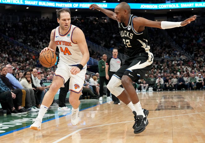 New York Knicks forward Bojan Bogdanovic (44) is guarded by Milwaukee Bucks forward Khris Middleton (22) during the first half of their game Sunday, April 7, 2024 at Fiserv Forum in Milwaukee, Wisconsin.