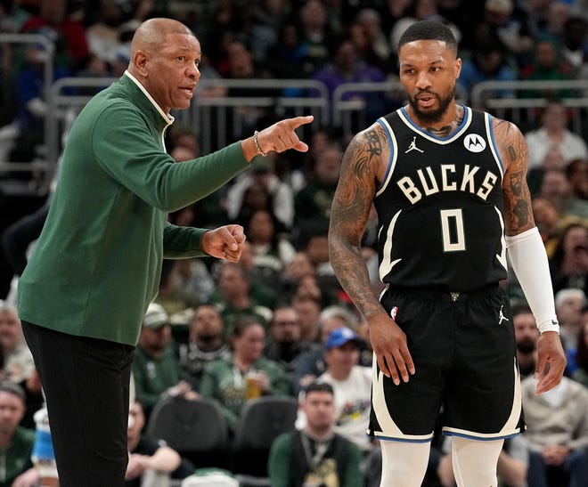 Milwaukee Bucks head coach Doc Rivers talks with Damian Lillard (0) during the first half of their game against the New York Knicks Sunday, April 7, 2024 at Fiserv Forum in Milwaukee, Wisconsin.