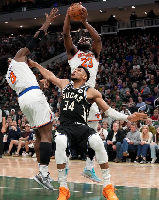 New York Knicks center Mitchell Robinson (23) out rebonds Milwaukee Bucks forward Giannis Antetokounmpo (34) during the second half of their game Sunday, April 7, 2024 at Fiserv Forum in Milwaukee, Wisconsin. The New York Knicks beat the Milwaukee Bucks 122-109.