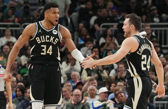 Milwaukee Bucks' Giannis Antetokounmpo (34) is congratulated by guard Pat Connaughton (24) after drawing a foul during the first half of their game against the New York Knicks Sunday, April 7, 2024 at Fiserv Forum in Milwaukee, Wisconsin.