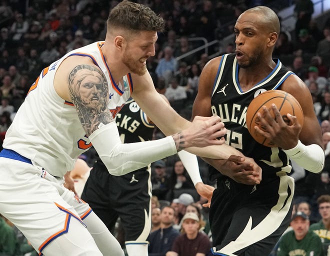 Milwaukee Bucks forward Khris Middleton (22) out rebounds New York Knicks center Isaiah Hartenstein (55) during the first half of their game Sunday, April 7, 2024 at Fiserv Forum in Milwaukee, Wisconsin.