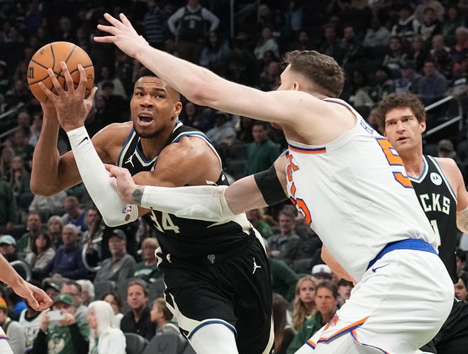 Milwaukee Bucks forward Giannis Antetokounmpo (34) is fouled by New York Knicks center Isaiah Hartenstein (55) during the second half of their game Sunday, April 7, 2024 at Fiserv Forum in Milwaukee, Wisconsin. The New York Knicks beat the Milwaukee Bucks 122-109.