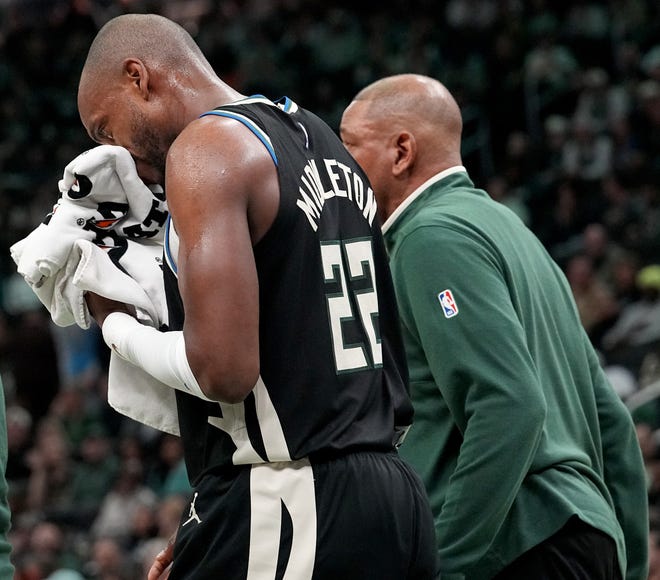 Milwaukee Bucks forward Khris Middleton (22) walks off the court with head coach Doc Rovers, right, after being injured during the first half of their game against the New York Knicks Sunday, April 7, 2024 at Fiserv Forum in Milwaukee, Wisconsin.