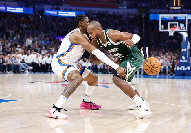 Bucks forward Khris Middleton has the ball poked away from him by Thunder forward Jalen Williams during the second quarter Friday night at Paycom Center.