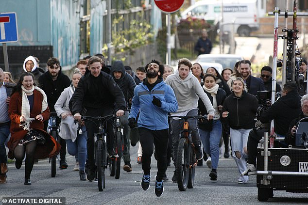 The Liverpool striker was pictured running away from a crowd of people as the cameras rolled