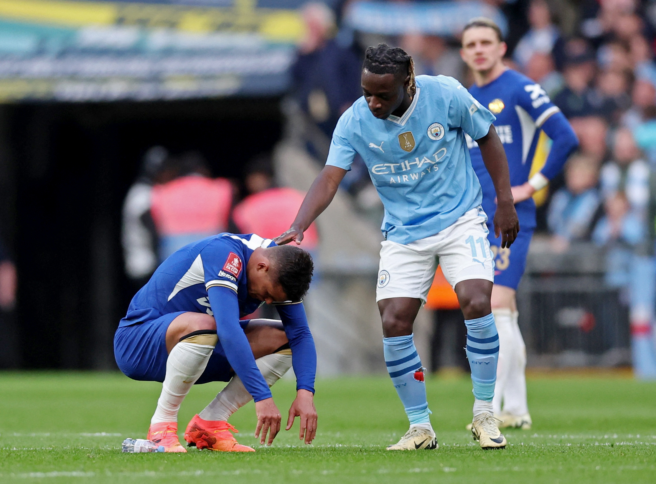 Jeremy Doku consoles Silva after the match