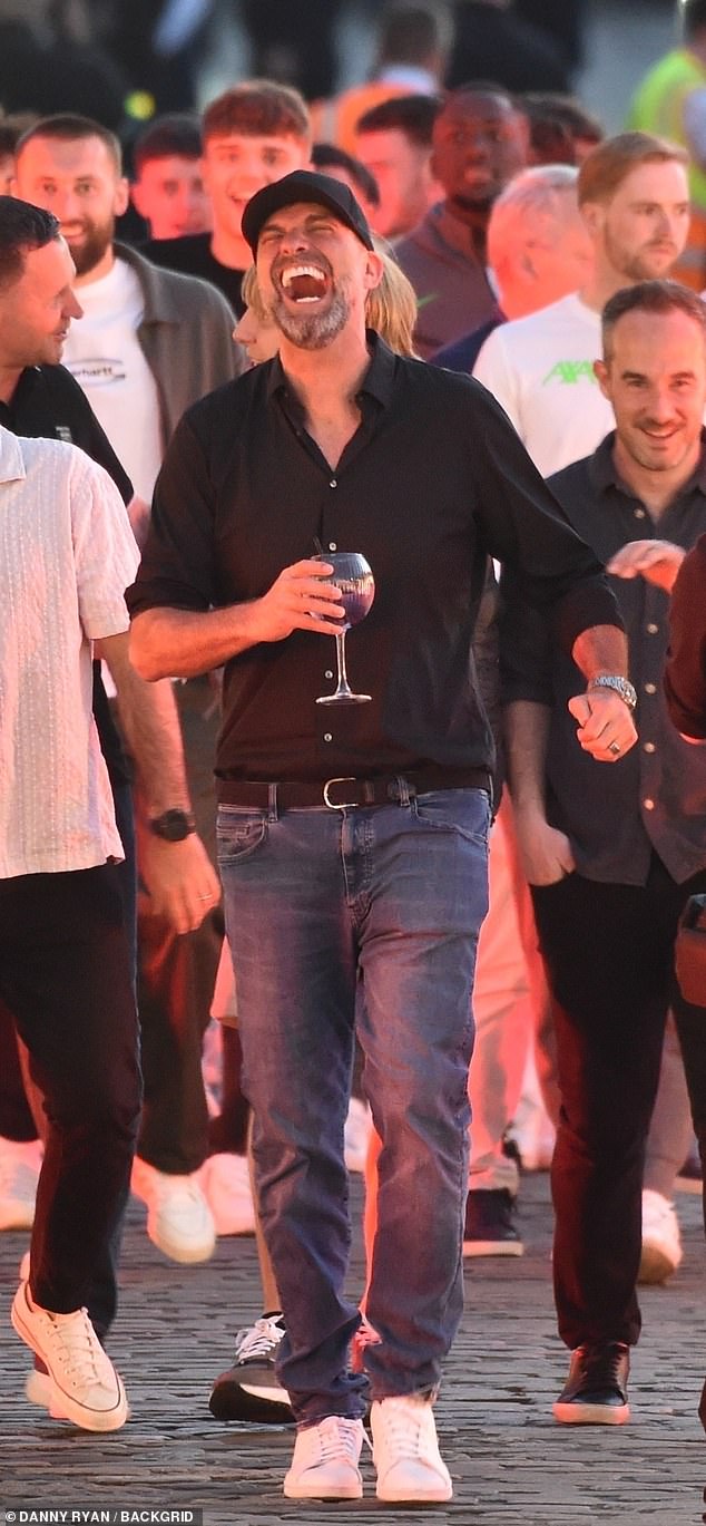 You'll never dance alone! Jurgen Klopp shows off his moves as he is mobbed  by his players on night out to mark his Liverpool farewell - after also  throwing shapes on stage