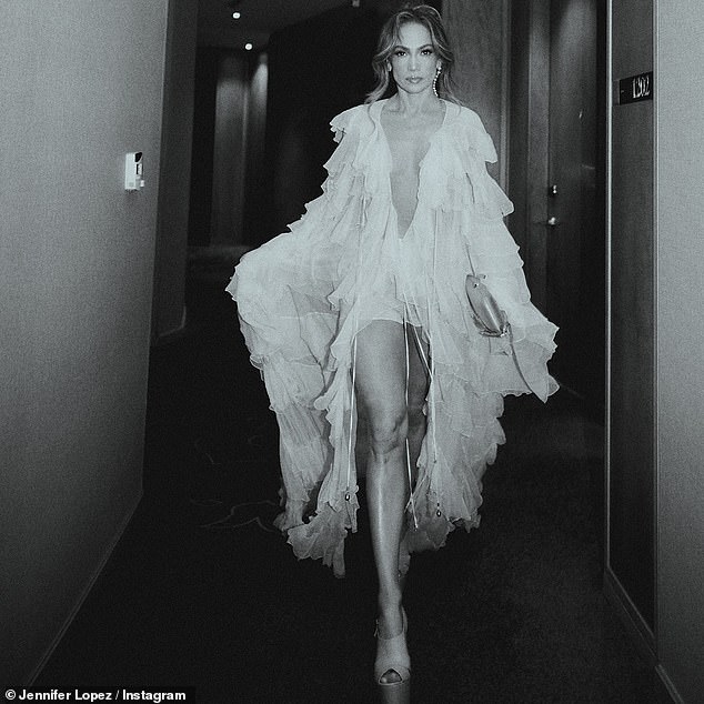 She shared black-and-white snaps of herself making a hotel hallway her runway and strutting in platform heels