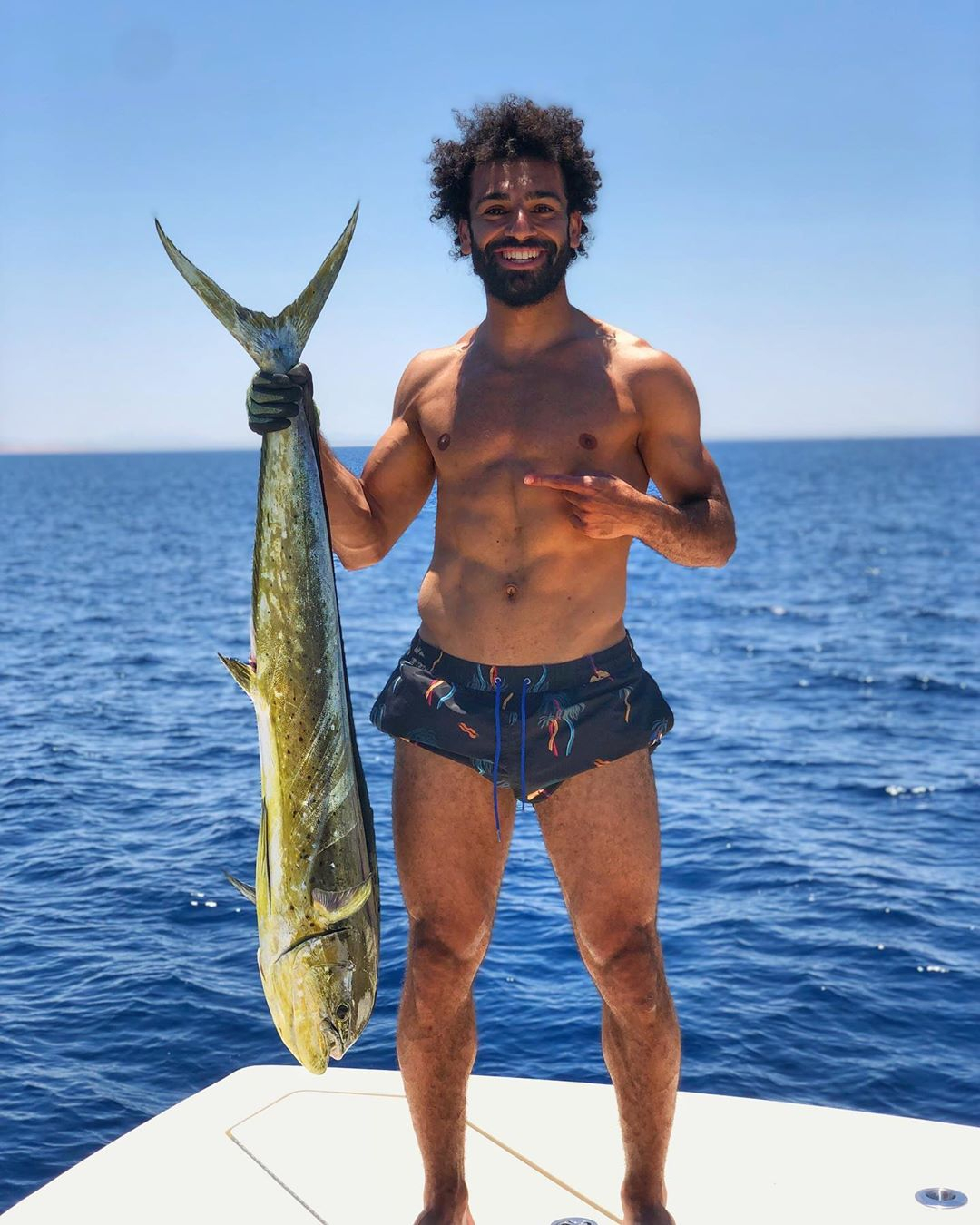 Liverpool's Mo Salah catches another big fish as Egyptian relaxes after Champions League glory | The Sun