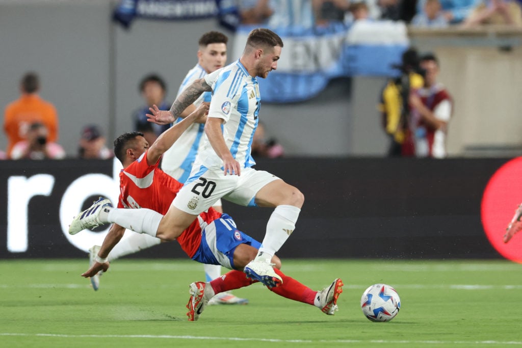 Argentina's midfielder #20 Alexis Mac Allister fights for the ball with Chile's forward #10 Alexis Sanchez during the Conmebol 2024 Copa America to...