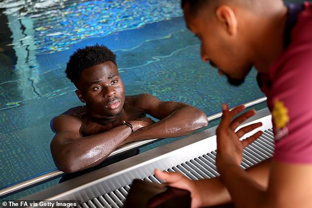 Some of the players including Bukayo Saka relaxed in the pool whilst studying footage