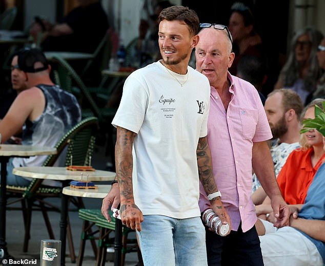 Ben White (left) was pictured holding nicotine pouches and two cigars as he enjoys a family holiday in Ibiza after refusing to be called up for Gareth Southgate's England squad