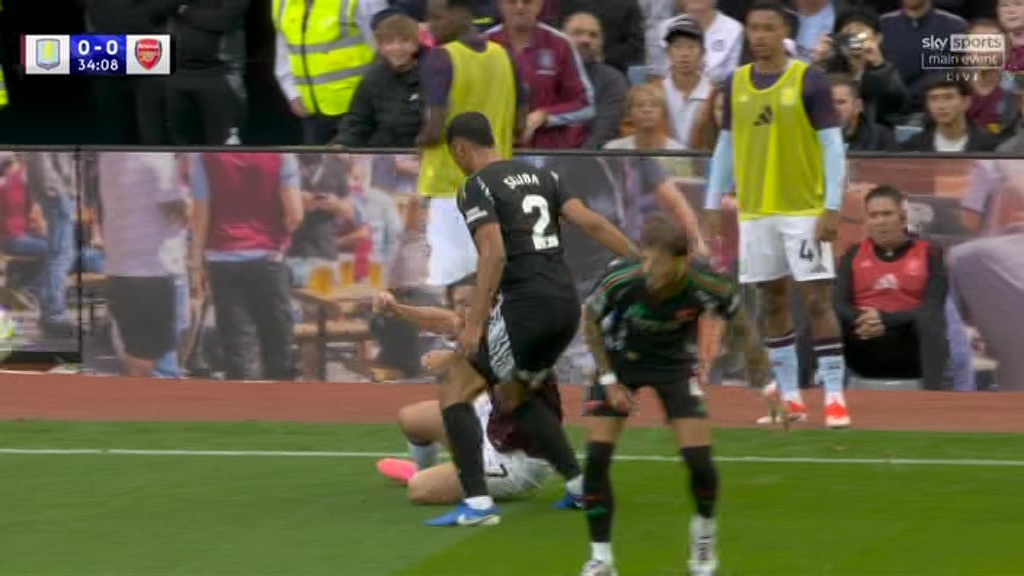 McGinn was then floored by the ball being kicked at him by Ben White