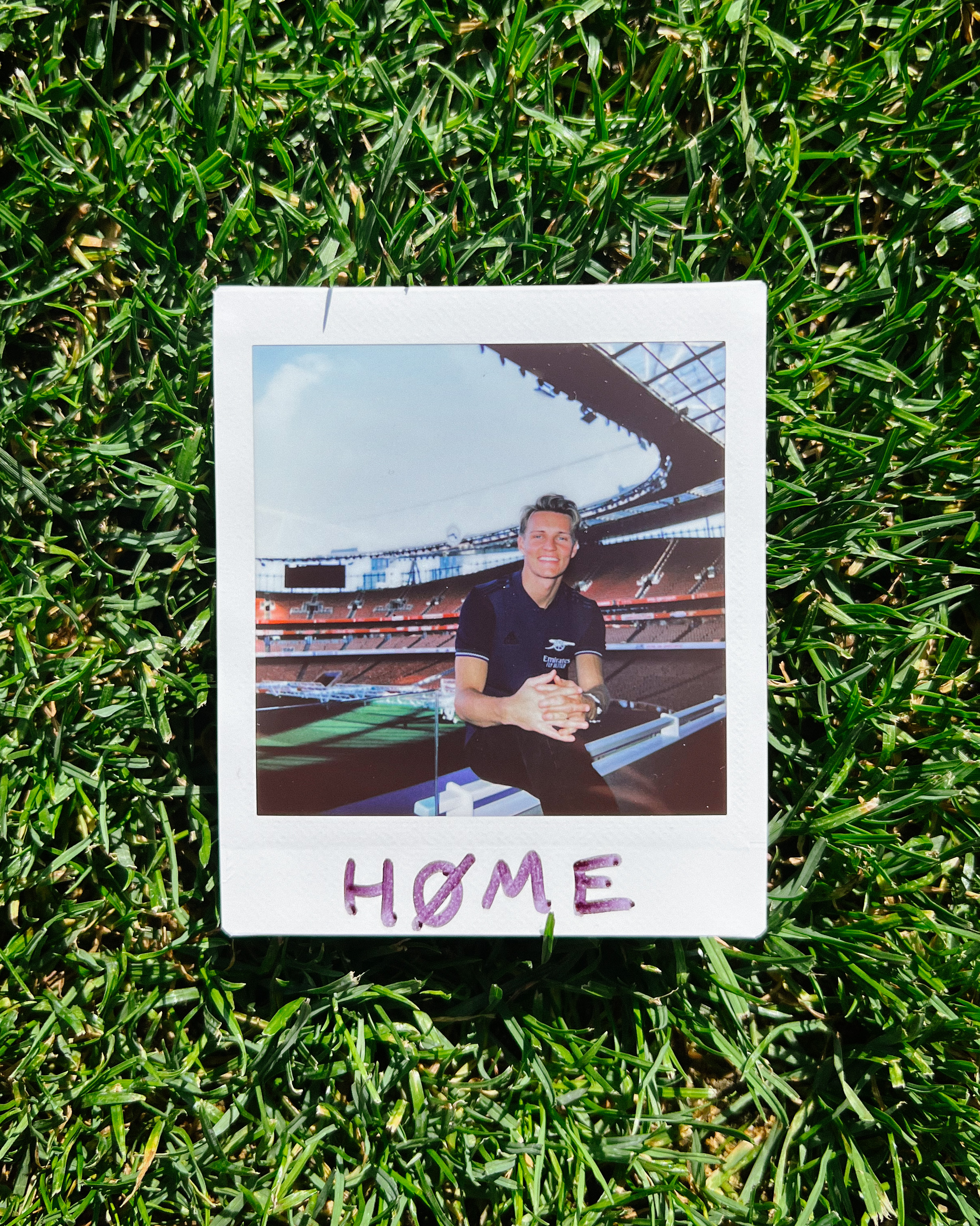 A polaroid photograph of Martin Odegaard at Emirates Stadium.